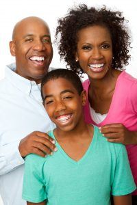 happy child with braces & parents 