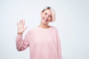 woman waiving at their orthodontist in Powell