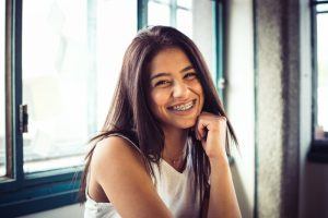 Young girl smiling with braces 