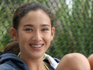 smiling teenage girl with braces 