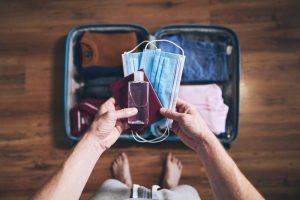 young man packing a suitcase 