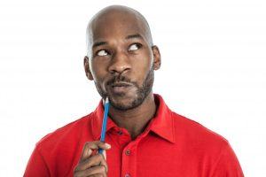 bald man in red shirt thinking about something 