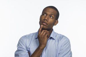 young man thinking while looking off camera 