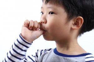 young boy sucking their thumb 