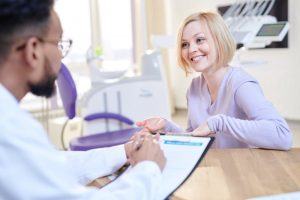 woman talking to orthodontist about dental insurance 